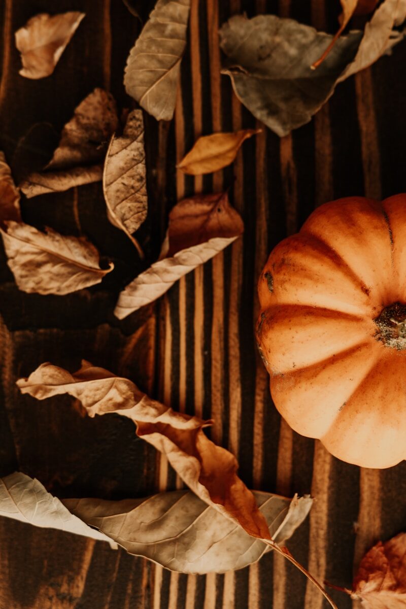 A pumpkin sitting on top of a wooden table